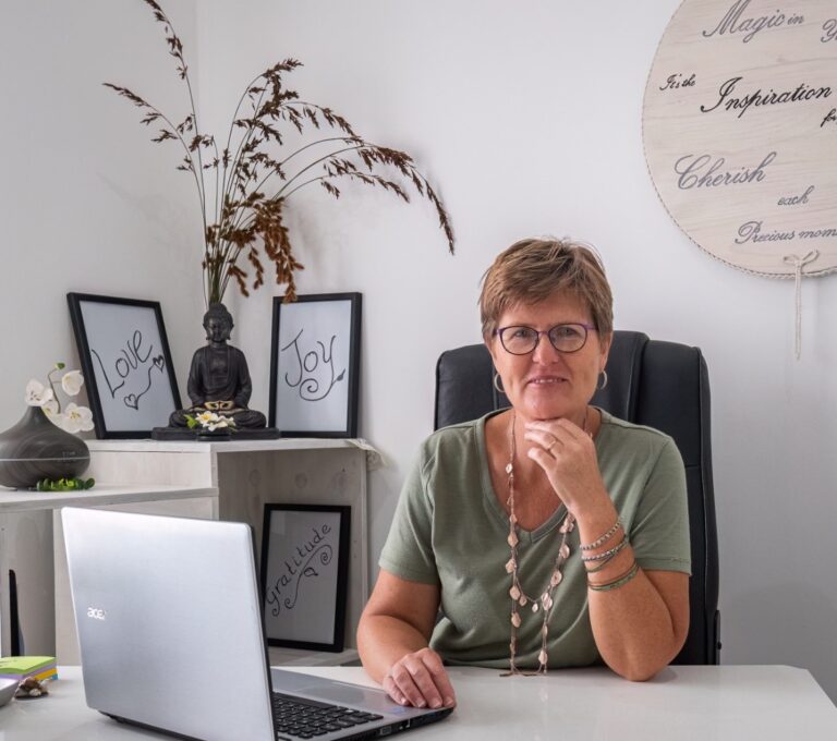 Tina Green Top at desk